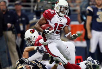 ST. LOUIS - NOVEMBER 02:  Steve Breaston #15 of the Arizona Cardinals is pulled down by Chris Chamberlain #57 of the St. Louis Rams on November 2, 2008 at the Edwards Jones Dome in St. Louis, Missouri. The Arizona Cardinals defeated the St. Louis Rams 34-13. (Photo by Elsa/Getty Images)
