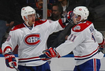 UNIONDALE, NY - APRIL 02: Andrei MArkov #79 (L) and Saku Koivu #11 (R) of the Montreal Canadiens celebrate a second period goal against the New York Islanders on April 2, 2009 at the Nassau Coliseum in Uniondale, New York. The Canadiens defeated the Islanders 5-1. (Photo by Bruce Bennett/Getty Images)