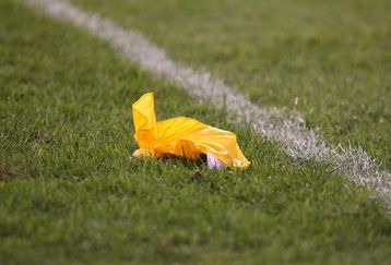 CHICAGO - AUGUST 22: A referees' penalty flag lies on the field during a pre-season game between the Chicago Bears and the New York Giants on August 22, 2009 at Soldier Field in Chicago, Illinois. The Bears defeated the Giants 17-3. (Photo by Jonathan Daniel/Getty Images)