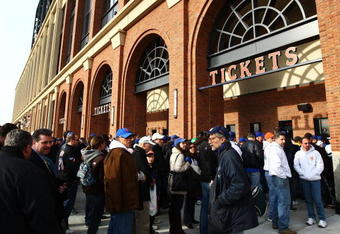 NEW YORK - APRIL 13: Fans wait at the ticket window outside of Citi Field before opening day on April 13, 2009 in the Flushing neighborhood of the Queens borough of New York City. This is the first regular season MLB game being played at the new venue which replaced Shea stadium as the Mets home field.  (Photo by Chris McGrath/Getty Images)