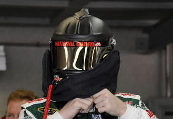 INDIANAPOLIS - JULY 24:  Dale Earnhardt Jr., driver of the #88 AMP Energy/National Guard Chevrolet, puts on his helmet in the garage prior to practice for the NASCAR Sprint Cup Series Allstate 400 at the Brickyard at Indianapolis Motor Speedway on July 24, 2009 in Indianapolis, Indiana.  (Photo by John Harrelson/Getty Images for NASCAR)