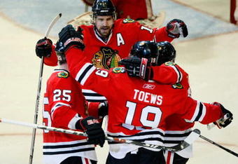 CHICAGO - MAY 24:  (L-R) Cam Barker #25, Patrick Sharp #10, Jonathan Toews #19 and Patrick Kane #88 of the Chicago Blackhawks celebrate after Toews scored a goal in the second period against the Detroit Red Wings during Game Four of the Western Conference Championship Round of the 2009 Stanley Cup Playoffs on May 24, 2009 at the United Center in Chicago, Illinois.  (Photo by Jim Prisching/Getty Images)