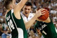DETROIT - APRIL 06:  Tyler Hansbrough #50 of the North Carolina Tar Heels drives to the basket between Goran Suton #14 and Kalin Lucas #1 of the Michigan State Spartans in the second half during the 2009 NCAA Division I Men's Basketball National Championship game at Ford Field on April 6, 2009 in Detroit, Michigan.  (Photo by Streeter Lecka/Getty Images)