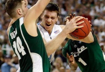 DETROIT - APRIL 06:  Tyler Hansbrough #50 of the North Carolina Tar Heels drives to the basket between Goran Suton #14 and Kalin Lucas #1 of the Michigan State Spartans in the second half during the 2009 NCAA Division I Men's Basketball National Championship game at Ford Field on April 6, 2009 in Detroit, Michigan.  (Photo by Streeter Lecka/Getty Images)