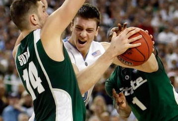 DETROIT - APRIL 06:  Tyler Hansbrough #50 of the North Carolina Tar Heels drives to the basket between Goran Suton #14 and Kalin Lucas #1 of the Michigan State Spartans in the second half during the 2009 NCAA Division I Men's Basketball National Championship game at Ford Field on April 6, 2009 in Detroit, Michigan.  (Photo by Streeter Lecka/Getty Images)