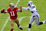 SAN FRANCISCO - AUGUST 22: Alex Smith #11 of the San Francisco 49ers passes against Greg Ellis #99 of the Oakland Raiders during a preseason game on August 22, 2009 at Candlestick Park in San Francisco, California.  (Photo by Jed Jacobsohn/Getty Images)