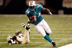 NEW ORLEANS - SEPTEMBER 03:  Ricky Williams #34 of the Miami Dolphins avoids a tackle by Danny Gorrer #38 of the New Orleans Saints at the Louisiana Superdome on September 3, 2009 in New Orleans, Louisiana.  (Photo by Chris Graythen/Getty Images)