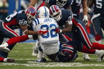 ORCHARD PARK, NY - NOVEMBER 23:  Kevin Thomas #28 and Lawyer Milloy #36 of the Buffalo Bills gang tackle Edgerring James #32 of the Indianapolis Colts on November 23, 2003 at Ralph Wilson Stadium in Orchard Park, New York. The Colts defeated the Bills 17-14. (Photo by Rick Stewart/Getty Images)