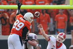 STILLWATER, OK - SEPTEMBER 05:  Quarterback Joe Cox #14 of the Georgia Bulldogs throws a pass that is deflected by tight end Cooper Bassett #80 of the Oklahoma State Cowboys during the college football game at Boone Pickens Stadium on September 5, 2009 in Stillwater, Oklahoma.  The Cowboys defeated the Bulldogs 24-10.  (Photo by Christian Petersen/Getty Images)