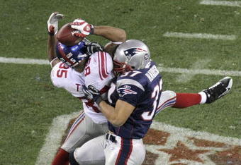 GLENDALE, AZ - FEBRUARY 03:  David Tyree #85 of the New York Giants catches a 32-yard pass from Eli Manning #10 as Rodney Harrison #37 of the New England Patriots attempts to knock it out in the fourth quarter of Super Bowl XLII on February 3, 2008 at the University of Phoenix Stadium in Glendale, Arizona. The Giants defeated the Patriots 17-14.  (Photo by Doug Pensinger/Getty Images)