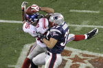 GLENDALE, AZ - FEBRUARY 03:  David Tyree #85 of the New York Giants catches a 32-yard pass from Eli Manning #10 as Rodney Harrison #37 of the New England Patriots attempts to knock it out in the fourth quarter of Super Bowl XLII on February 3, 2008 at the University of Phoenix Stadium in Glendale, Arizona. The Giants defeated the Patriots 17-14.  (Photo by Doug Pensinger/Getty Images)