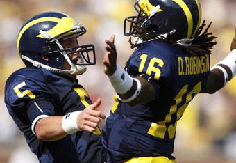ANN ARBOR, MI - SEPTEMBER 05:  Tate Forcier #5 of the Michigan Wolverines celebrates with Denard Robinson #16 after Robinson ran for a long first quarter touchdown against the Western Michigan Broncos on September 5, 2009 at Michigan Stadium in Ann Arbor, Michigan.  (Photo by Gregory Shamus/Getty Images)