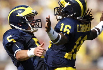 ANN ARBOR, MI - SEPTEMBER 05:  Tate Forcier #5 of the Michigan Wolverines celebrates with Denard Robinson #16 after Robinson ran for a long first quarter touchdown against the Western Michigan Broncos on September 5, 2009 at Michigan Stadium in Ann Arbor, Michigan.  (Photo by Gregory Shamus/Getty Images)