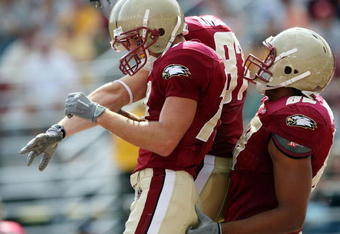 CHESTNUT HILL, MA - SEPTEMBER 05:  Billy Flutie #14 of the Boston College Eagles is congratulated by teammates Lars Anderson #87 and Mike Naples #89 after Flutie scored a touchdown against the Northeastern Huskies on September 5, 2009 at Alumni Stadium in Chestnut Hill, Massachusetts.  (Photo by Elsa/Getty Images)