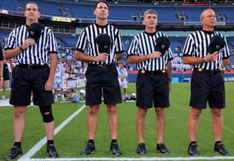 DENVER - JULY 16:  The referees observe the national anthem as the Old School prepares to face the Young Guns during the 2009 Major League Lacrosse All Star Game at INVESCO Field at Mile High on July 16, 2009 in Denver, Colorado. The Old School team defeated the Young Guns 22-21 in overtime.  (Photo by Doug Pensinger/Getty Images)