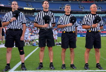 DENVER - JULY 16:  The referees observe the national anthem as the Old School prepares to face the Young Guns during the 2009 Major League Lacrosse All Star Game at INVESCO Field at Mile High on July 16, 2009 in Denver, Colorado. The Old School team defeated the Young Guns 22-21 in overtime.  (Photo by Doug Pensinger/Getty Images)