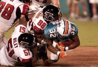 Atlanta Falcons defenders stop Miami Dolphins kick returner Charlie Rogers during the first quarter  August 22, 2003  at Pro Player Stadium, Miami, Florida.   The  Dolphins defeated the  Falcons 30 - 21 in a pre-season game.  (Photo by Al Messerschmidt/Getty Images)