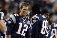 FOXBORO, MA - SEPTEMBER 03:  Tom Brady #12 of the New England Patriots and Randy Moss #81 celebrate in the fourth quarter against the New York Giants on September 3, 2009 at Gillette Stadium in Foxboro, Massachusetts. The Patriots defeated the Giants 38-27.  (Photo by Elsa/Getty Images)