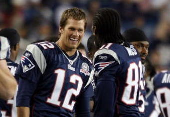 FOXBORO, MA - SEPTEMBER 03:  Tom Brady #12 of the New England Patriots and Randy Moss #81 celebrate in the fourth quarter against the New York Giants on September 3, 2009 at Gillette Stadium in Foxboro, Massachusetts. The Patriots defeated the Giants 38-27.  (Photo by Elsa/Getty Images)