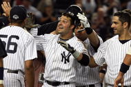 NEW YORK - SEPTEMBER 08:  Nick Swisher #33 of the New York Yankees celebrates his game-winning home run against the Tampa Bay Rays with his teammates on September 8, 2009 at Yankee Stadium in the Bronx borough of New York City. The Yankees won the game 3-2.  (Photo by Jim McIsaac/Getty Images)