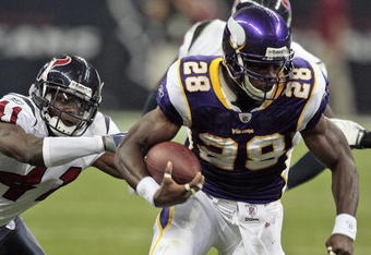 HOUSTON - AUGUST 31:  Running back Adrian Peterson #28 of the Minnesota Vikings breaks a tackle by cornerback Brice McCain #41 of the Houston Texans at Reliant Stadium on August 31, 2009 in Houston, Texas.  (Photo by Bob Levey/Getty Images)