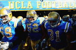PASADENA, CA - SEPTEMBER 05:  (L-R) Brandon Bennett #69, Christian Yount #52, and Trevor Theriot #31 of the UCLA Bruins walk onto the feild before the game against San Diego State at the Rose Bowl on September 5, 2009 in Pasadena, California.  (Photo by Jacob de Golish/Getty Images)