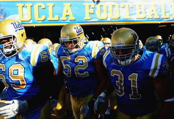 PASADENA, CA - SEPTEMBER 05:  (L-R) Brandon Bennett #69, Christian Yount #52, and Trevor Theriot #31 of the UCLA Bruins walk onto the feild before the game against San Diego State at the Rose Bowl on September 5, 2009 in Pasadena, California.  (Photo by Jacob de Golish/Getty Images)