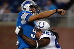 DETROIT, MI - AUGUST 28: Quarterback Matthew Stafford #9 of the Detroit Lions is tackled by defensive end Marcus Howard #92 of the Indianapolis Colts at Ford Field on August 28, 2009 in Detroit, Michigan.  (Photo by Scott Boehm/Getty Images)