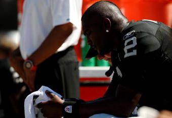 OAKLAND, CA - AUGUST 29: Quarterback JaMarcus Russell #2 of the Oakland Raiders sits on the bench during the preseason game against the New Orleans Saints at Oakland-Alameda County Coliseum on August 29, 2009 in Oakland, California. (Photo by Jed Jacobsohn/Getty Images)