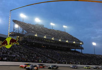 RICHMOND, VA - MAY 02:  Brian Vickers, driver of the #83 Red Bull Toyota, drives leads the field past the grandstand during the NASCAR Sprint Cup Series Crown Royal Presents the Russ Friedman 400 at Richmond International Raceway on May 2, 2009 in Richmond, Virginia.  (Photo by Rusty Jarrett/Getty Images for NASCAR)