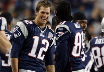 FOXBORO, MA - SEPTEMBER 03:  Tom Brady #12 of the New England Patriots and Randy Moss #81 celebrate in the fourth quarter against the New York Giants on September 3, 2009 at Gillette Stadium in Foxboro, Massachusetts. The Patriots defeated the Giants 38-27.  (Photo by Elsa/Getty Images)