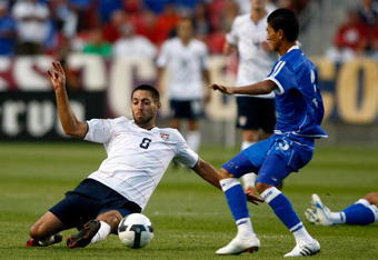 SANDY, UT - SEPTEMBER 05:  Clint Dempsey #8 of the United States slides to get the ball against Marvin Gonzales #3 during the FIFA 2010 World Cup Qualifier match between the United States and El Salvador at Rio Tinto Stadium on September 5, 2009 in Sandy, Utah.  (Photo by Jonathan Ferrey/Getty Images)