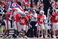 COLUMBUS, OH - SEPTEMBER 05:  Ohio State Buckeyes players congratulate Brian Rolle #36 of the Buckeyes after Rolle intercepted a Navy Midshipmen two-point conversion attempt and returned it 100 yards to the Navy endzone at Ohio Stadium on September 5, 2009 in Columbus, Ohio. Ohio State was granted the two points and held off Navy 31-27.  (Photo by Jamie Sabau/Getty Images)