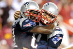LANDOVER, MD - AUGUST 28:  Tom Brady #12 and Randy Moss #81 of the New England Patriots celebrate after scoring a touchdown in the second quarter of a preseason game against the Washington Redskins at FedExField on August 28, 2009 in Landover, Maryland.  (Photo by Greg Fiume/Getty Images)