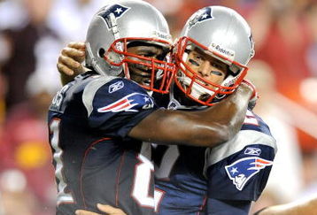 LANDOVER, MD - AUGUST 28:  Tom Brady #12 and Randy Moss #81 of the New England Patriots celebrate after scoring a touchdown in the second quarter of a preseason game against the Washington Redskins at FedExField on August 28, 2009 in Landover, Maryland.  (Photo by Greg Fiume/Getty Images)