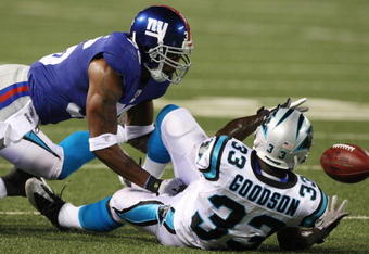 EAST RUTHERFORD, NJ - AUGUST 17:  Mike Goodson #33 of the Carolina Panthers attempts a catch against Travonti Johnson #36 of the New York Giants during the preseason NFL game at Giants Stadium on August 17, 2009 in East Rutherford, New Jersey. (Photo by Jim McIsaac/Getty Images)