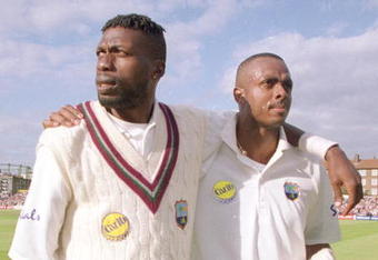 31 Aug 2000:  Curtley Ambrose (left) and Courtney Walsh of the West Indies leave the field for the last time during the fifth Test match against England at The Oval in London.  England won the match by 158 runs, and the series 3-1. \ Mandatory Credit: Laurence Griffiths /Allsport