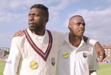 31 Aug 2000:  Curtley Ambrose (left) and Courtney Walsh of the West Indies leave the field for the last time during the fifth Test match against England at The Oval in London.  England won the match by 158 runs, and the series 3-1. \ Mandatory Credit: Laurence Griffiths /Allsport