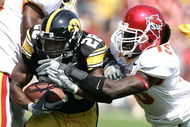 IOWA CITY, IA - SEPTEMBER 16: Running back Damian Sims #28 of the Iowa Hawkeyes runs with the football as linebacker Alvin Bowen #15 of the Iowa State Cyclones pursues at Kinnick Stadium on September 16, 2006 in Iowa City, Iowa. The Hawkeyes defeated Cyclones 27-17. (Photo by Scott Boehm/Getty Images)