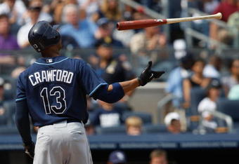 NEW YORK - SEPTEMBER 07:  Carl Crawford #13 of the Tampa Bay Rays throws hit bat in the air during the game against the New York Yankees on September 7, 2009 at Yankee Stadium in the Bronx borough of New York City.  (Photo by Jared Wickerham/Getty Images)