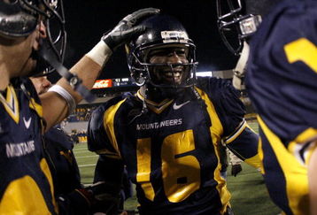 MORGANTOWN, WV - DECEMBER 2:  Jarrett Brown #16 of the Virginia Mountaineers celebrates with teammates after their 41-39 victory over the Rutgers Scarlet Knights at Milan Puskar Stadium December 2, 2006 in Morgantown, West Virginia.  (Photo by Gregory Shamus/Getty Images)