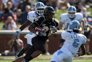 WINSTON SALEM, NC - OCTOBER 27:  Kenny Moore #21 of the Wake Forest Demon Deacons goes between Anthony Elzy #6 and Martel Thatch #21(behind)  of the UNC Tar Heels during the ACC game at the Groves Stadium, on October 27, 2007 in Winston Salem, North Carolina.  (Photo by David Cannon/Getty Images)