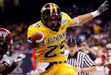 NEW ORLEANS - DECEMBER 21:  Damion Fletcher #25 of the Southern Mississippi Golden Eagles scores a touchdown over Jorrick Calvin #14 of the Troy Trojans during the R+L Carriers New Orleans Bowl on December 21, 2008 at the Superdome in New Orleans, Louisiana.  (Photo by Chris Graythen/Getty Images)