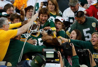 GREEN BAY, WI - AUGUST 22: Wide receiver Greg Jennings #85 of the Green Bay Packers jumps in the stands to celebrate with fans after scoring a touchdown against the Buffalo Bills at Lambeau Field on August 22, 2009 in Green Bay. Wisconsin.  (Photo by Scott Boehm/Getty Images)