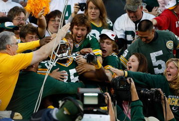 GREEN BAY, WI - AUGUST 22: Wide receiver Greg Jennings #85 of the Green Bay Packers jumps in the stands to celebrate with fans after scoring a touchdown against the Buffalo Bills at Lambeau Field on August 22, 2009 in Green Bay. Wisconsin.  (Photo by Scott Boehm/Getty Images)