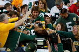 GREEN BAY, WI - AUGUST 22: Wide receiver Greg Jennings #85 of the Green Bay Packers jumps in the stands to celebrate with fans after scoring a touchdown against the Buffalo Bills at Lambeau Field on August 22, 2009 in Green Bay. Wisconsin.  (Photo by Scott Boehm/Getty Images)