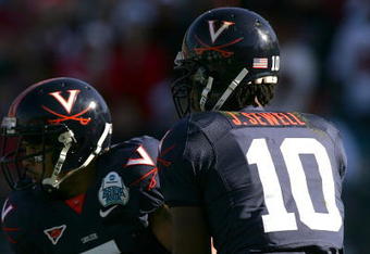 JACKSONVILLE, FL - JANUARY 01: Jameel Sewell #10 of the Virginia Cavaliers hands the ball off to Mikell Simpson #5 during the Gator Bowl against the Texas Tech Red Raiders at Jacksonville Municipal Stadium on January 1, 2008 in Jacksonville, Florida.  (Photo by Sam Greenwood/Getty Images)