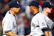 ATLANTA - JUNE 25:  Manager Joe Girardi #27 of the New York Yankees congratulates reliever Mariano Rivera #42 after he saved an 11-7 win over the Atlanta Braves at Turner Field on June 25, 2009 in Atlanta, Georgia.  (Photo by Kevin C. Cox/Getty Images)