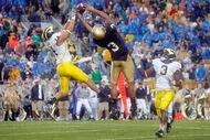 SOUTH BEND,IN - SEPTEMBER 13:  Morgan Trent #14 of the Michigan Wolverines reaches for the ball against Michael Floyd #3 of the Notre Dame Fighting Irish on September 13, 2008 at Notre Dame Stadium in South Bend, Indiana. (Photo by: Gregory Shamus/Getty Images)