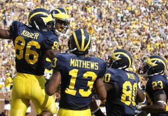 ANN ARBOR, MI - SEPTEMBER 05: Kevin Koger #86 of the Michigan Wolverines celebrates a second quarter touchdown catch with Greg Mathews #13, Martell Webb #80 and Carlos Brown #23 while playing the Western Michigan Broncos on September 5, 2009 at Michigan Stadium in Ann Arbor, Michigan.  (Photo by Gregory Shamus/Getty Images)
